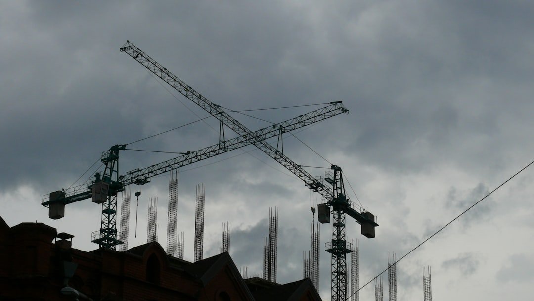 a large crane on top of a building under a cloudy sky
