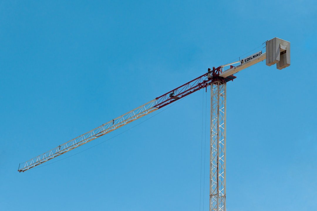 yellow crane under blue sky during daytime