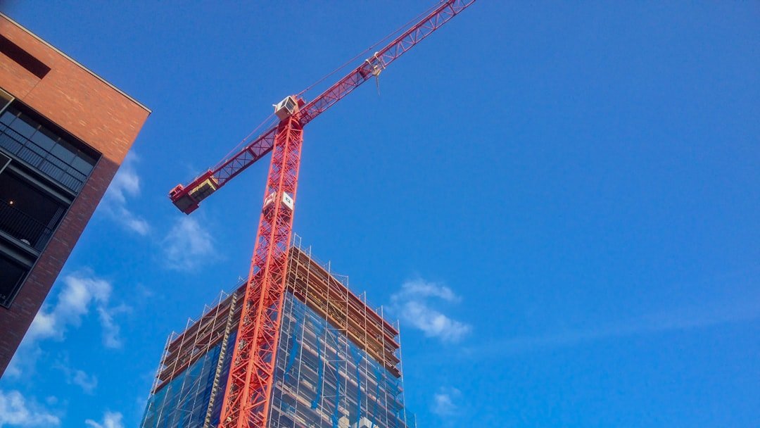 red crane near building during daytime