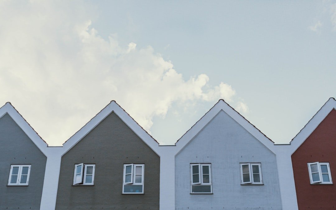 white and gray house under white clouds during daytime