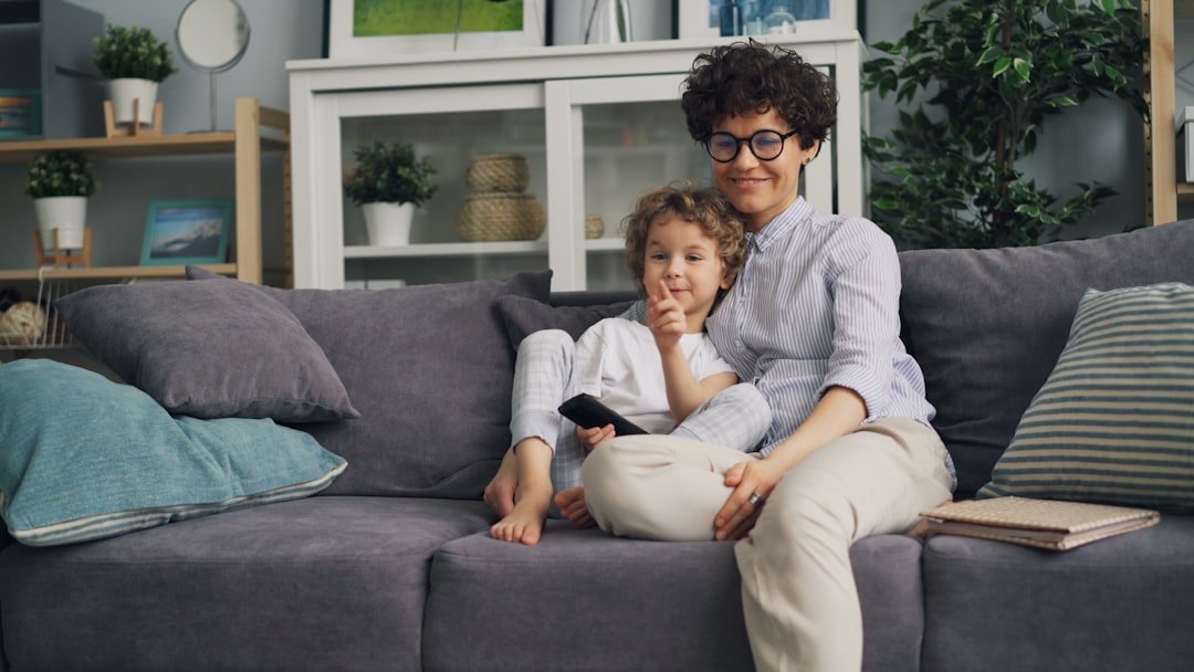a woman and a child sitting on a couch