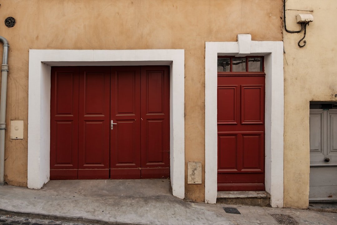 brown wooden door on white concrete wall