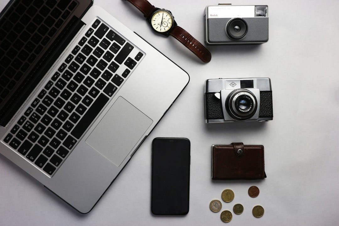black and silver camera beside macbook pro