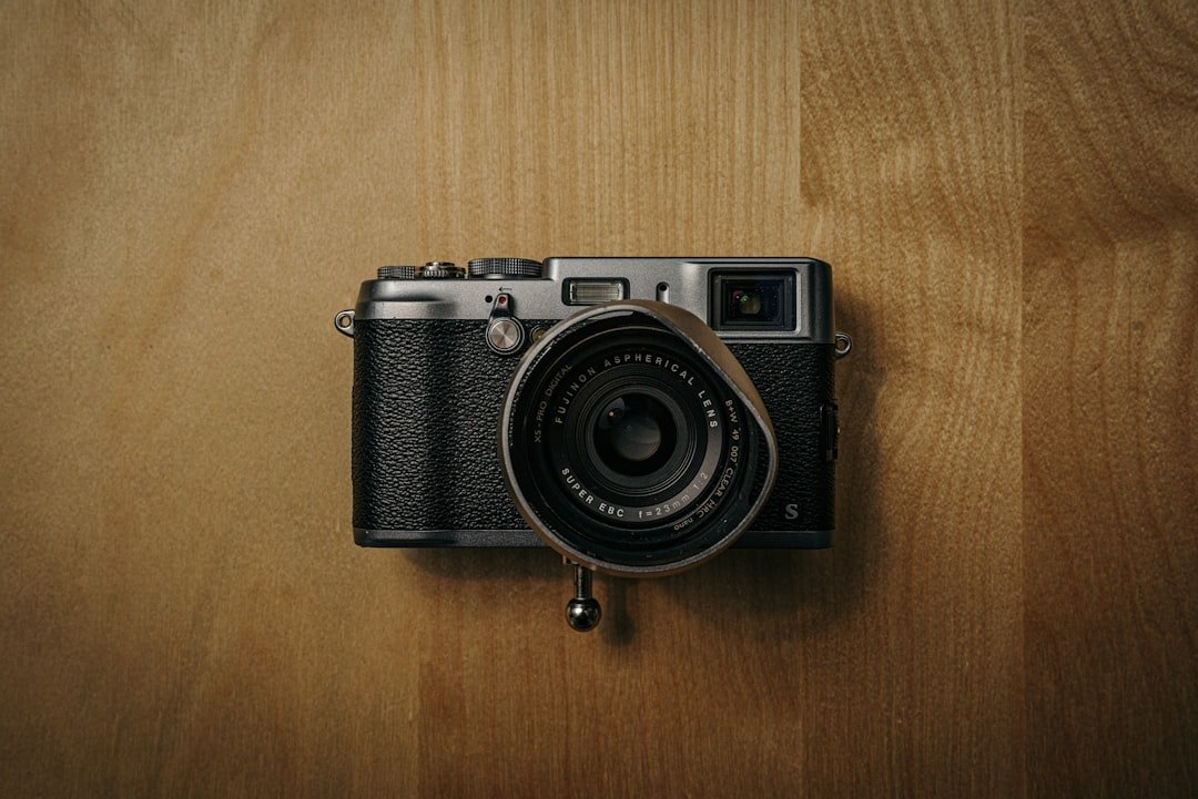 black and silver camera on brown wooden table