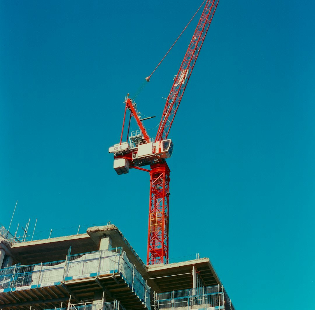 A crane is standing on top of a building
