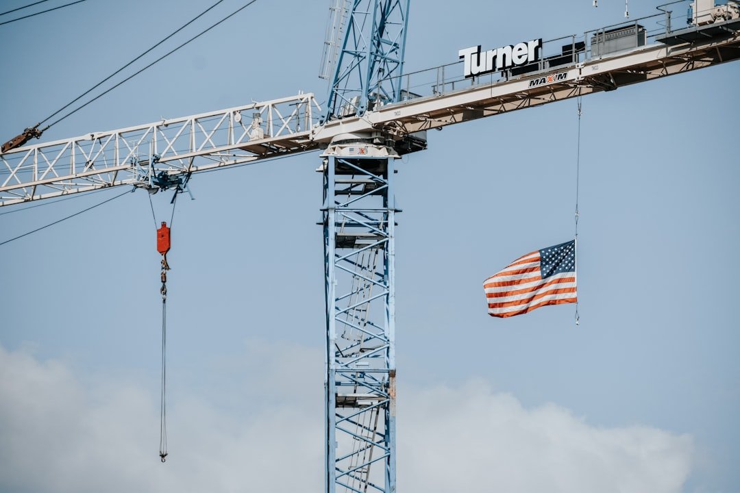 a large crane with a flag hanging off of it's side