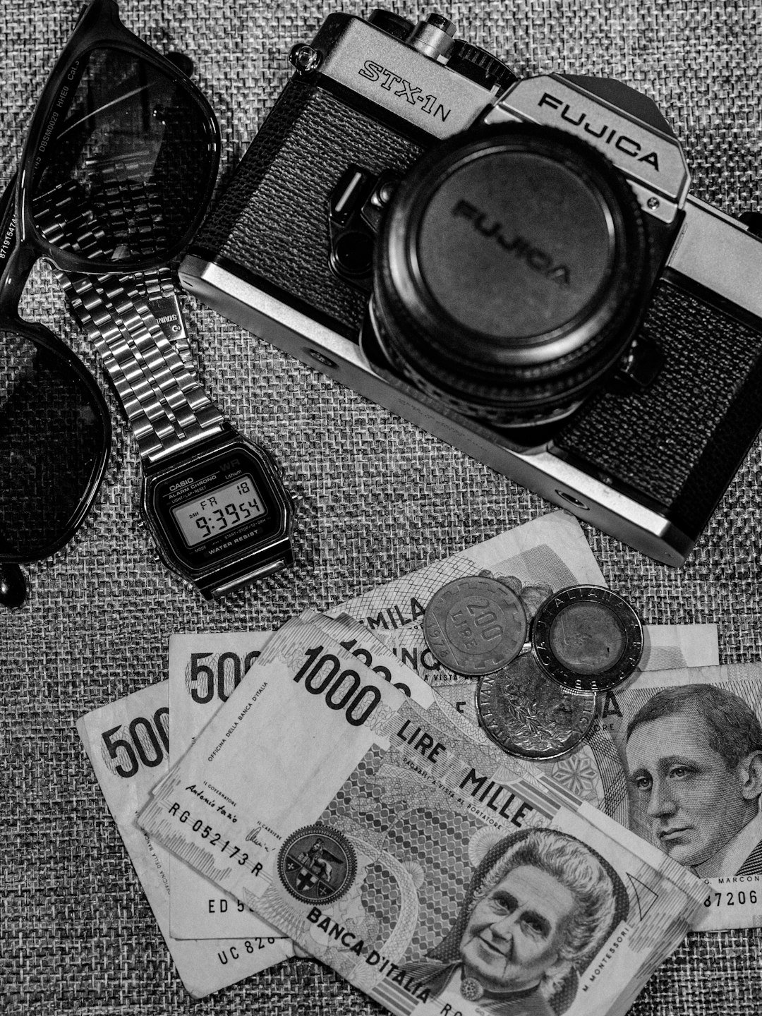 A black and white photo of a camera and money