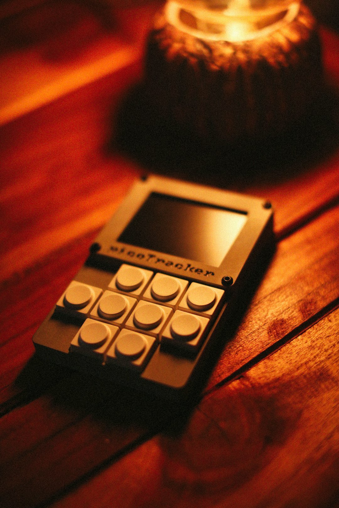 A sleeptracker device rests on a wooden surface.