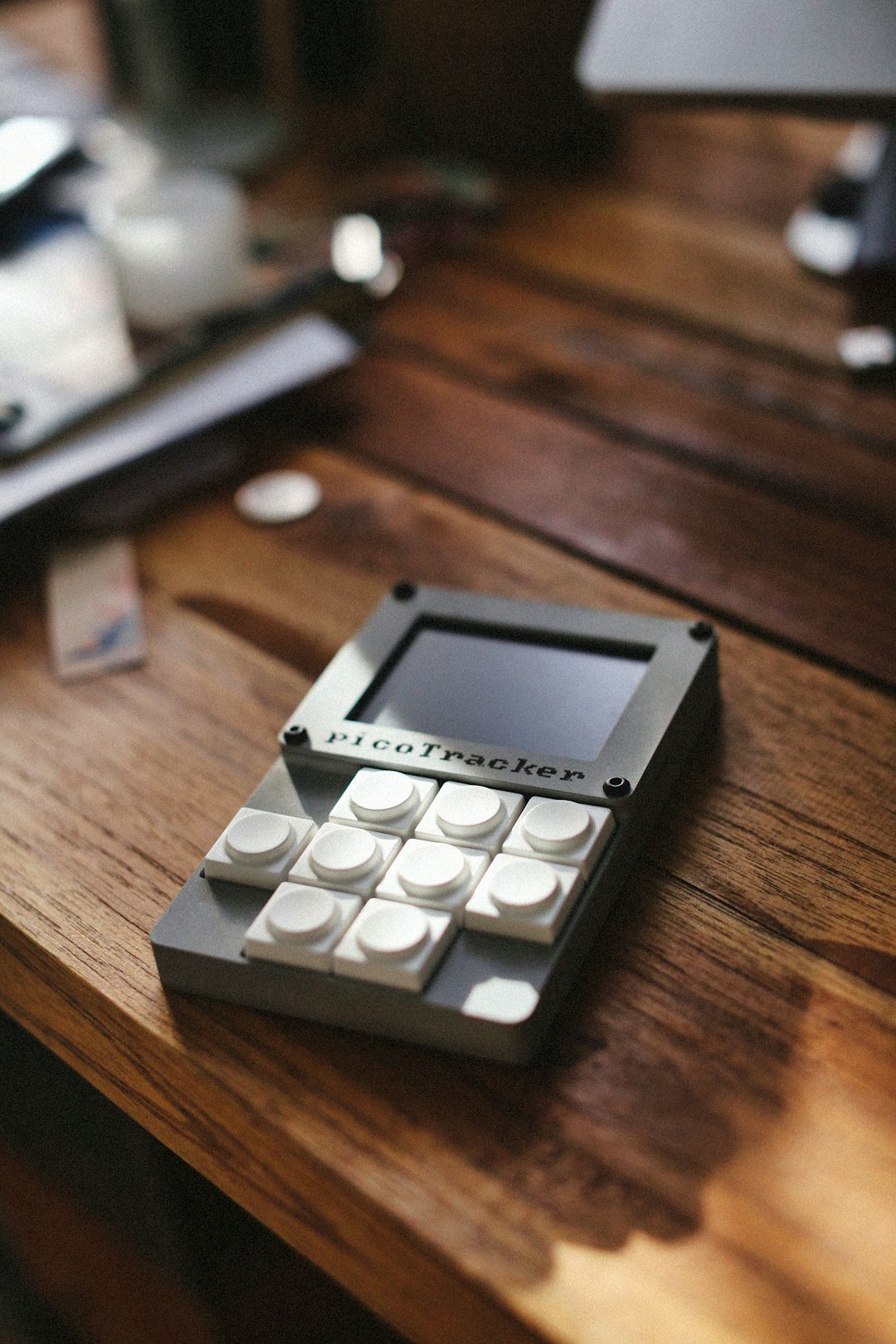 A small, unique device sits on a wooden table.
