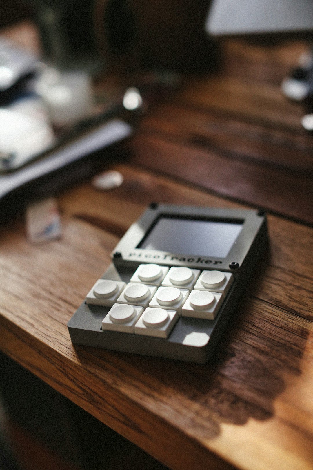 A close-up view of a tracker on a wooden table.