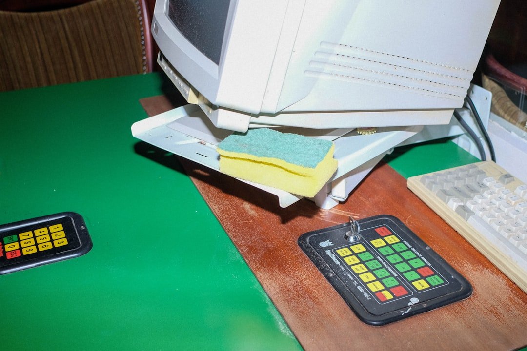 a computer monitor sitting on top of a desk next to a keyboard
