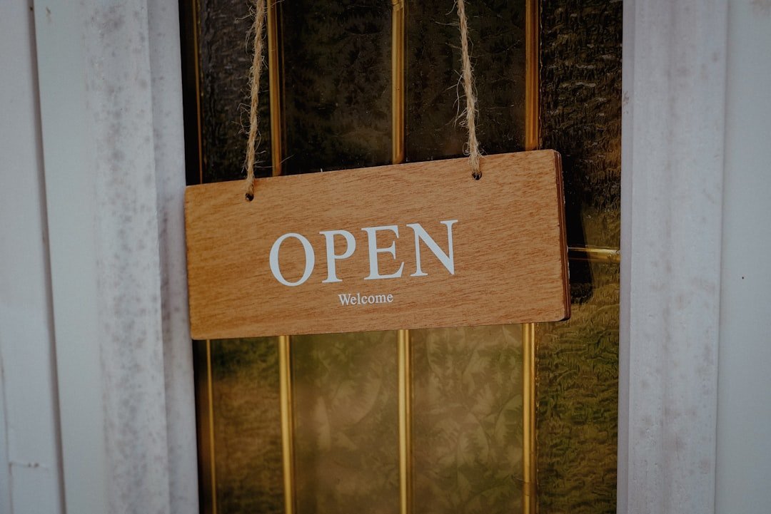 a wooden sign hanging from the front door of a building
