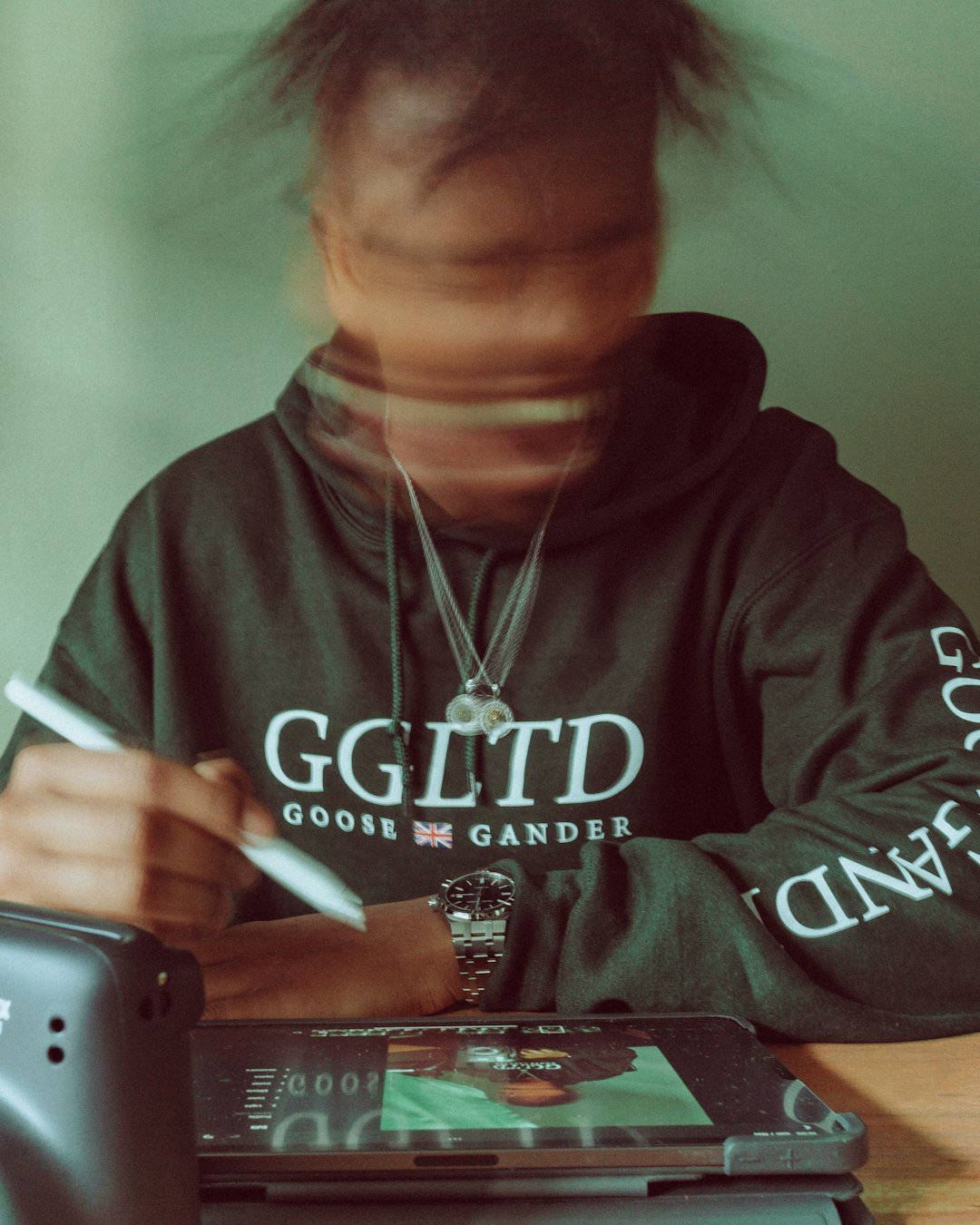 a person sitting at a table with a cell phone
