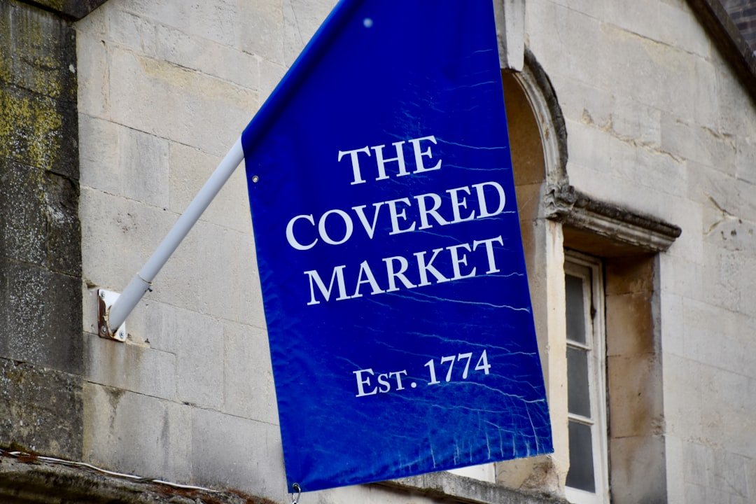 a blue sign hanging from the side of a building