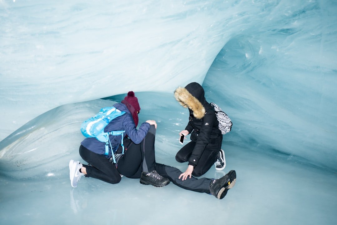 a couple of people that are sitting on some ice