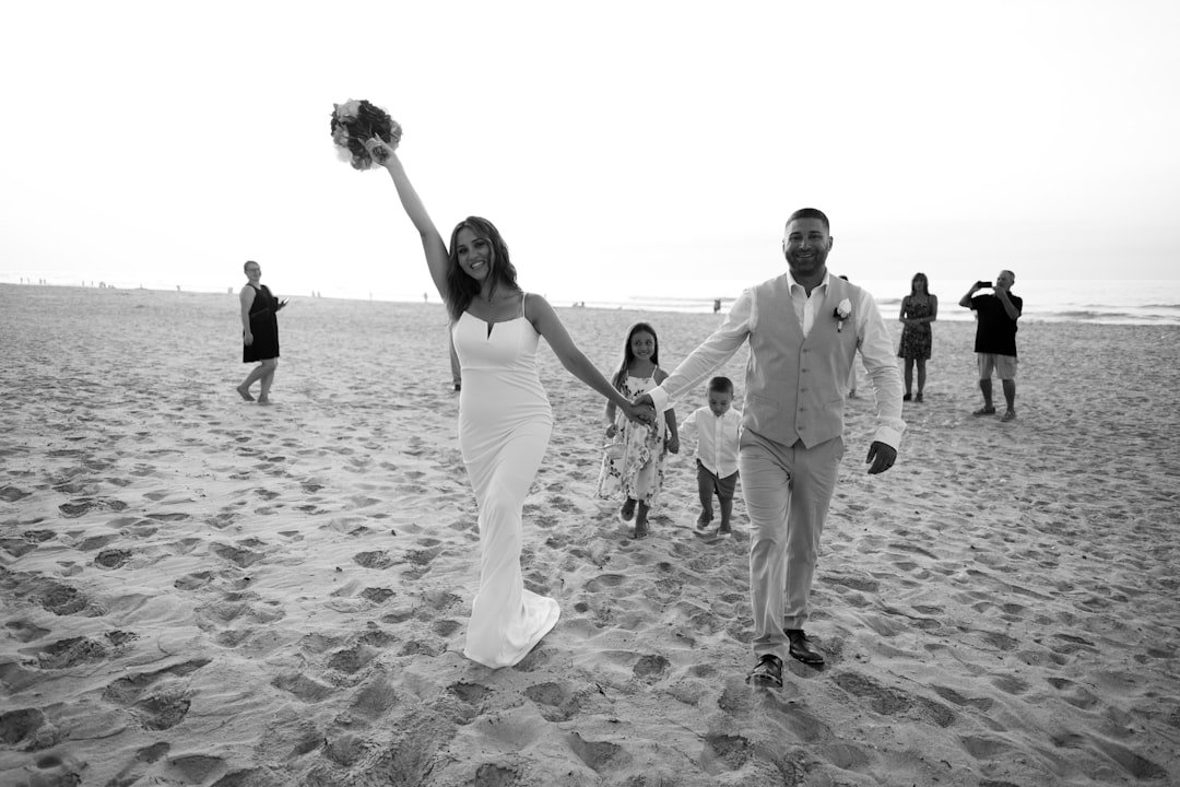 A man and a woman holding hands on a beach
