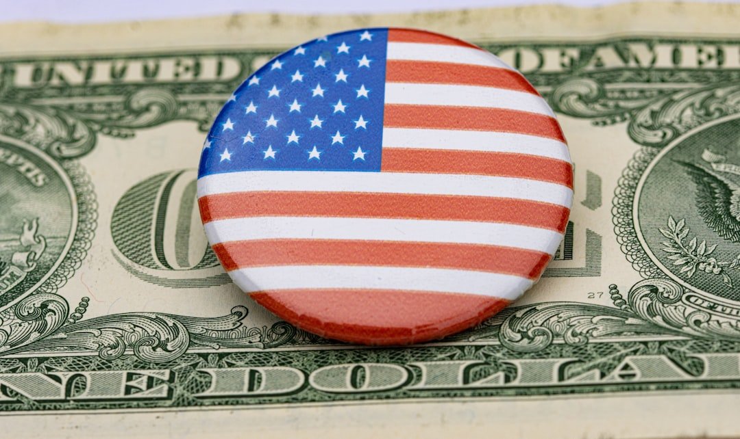 a button with the american flag on top of a dollar bill