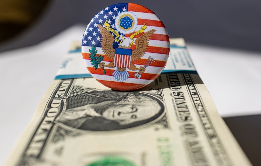 A button on top of a one dollar bill