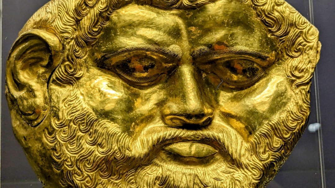 A close up of a gold statue of a man