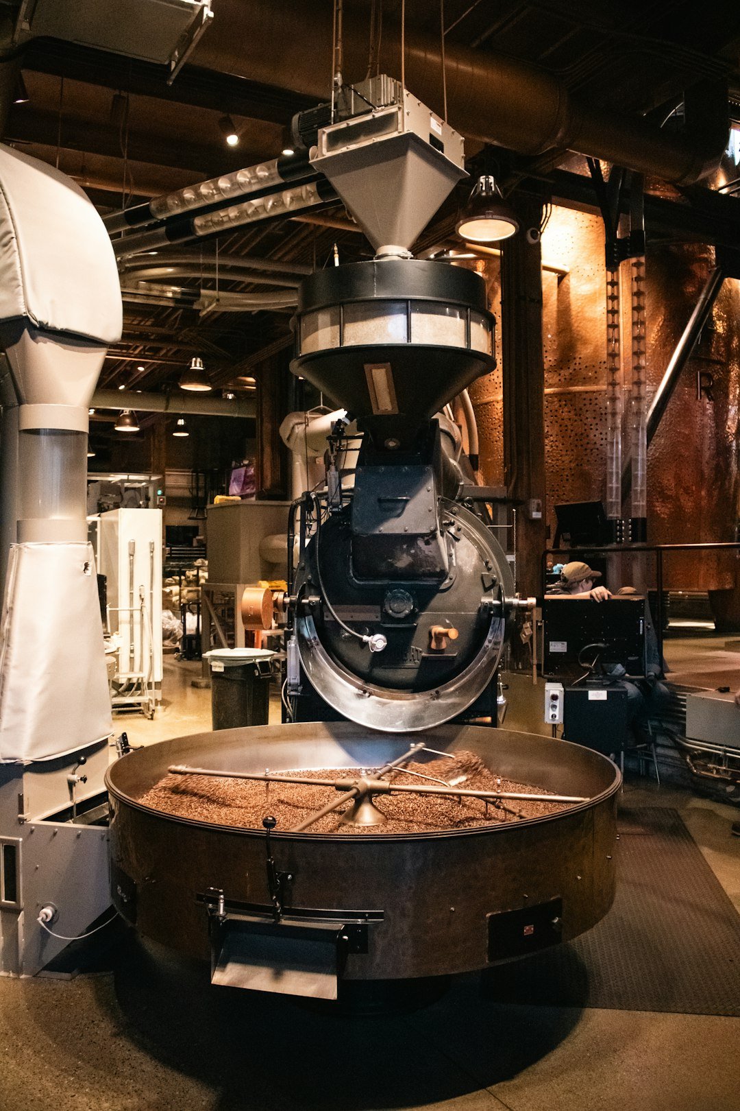 Coffee beans being roasted in a commercial roaster.