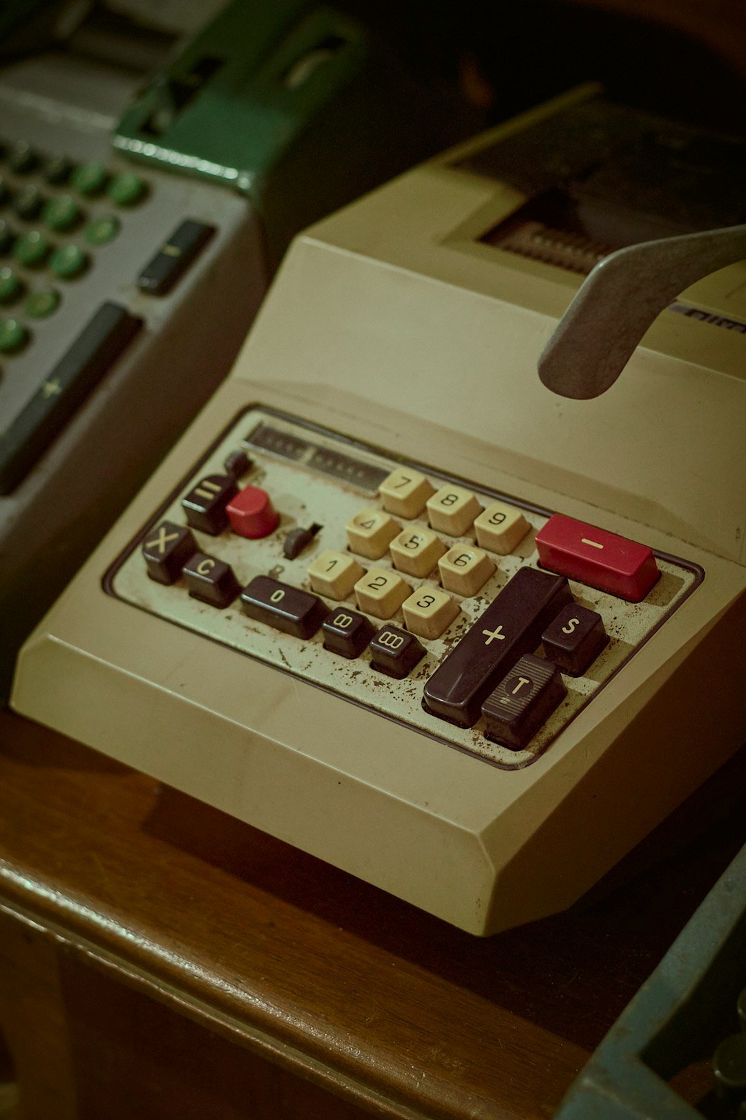 A calculator sitting on top of a wooden table